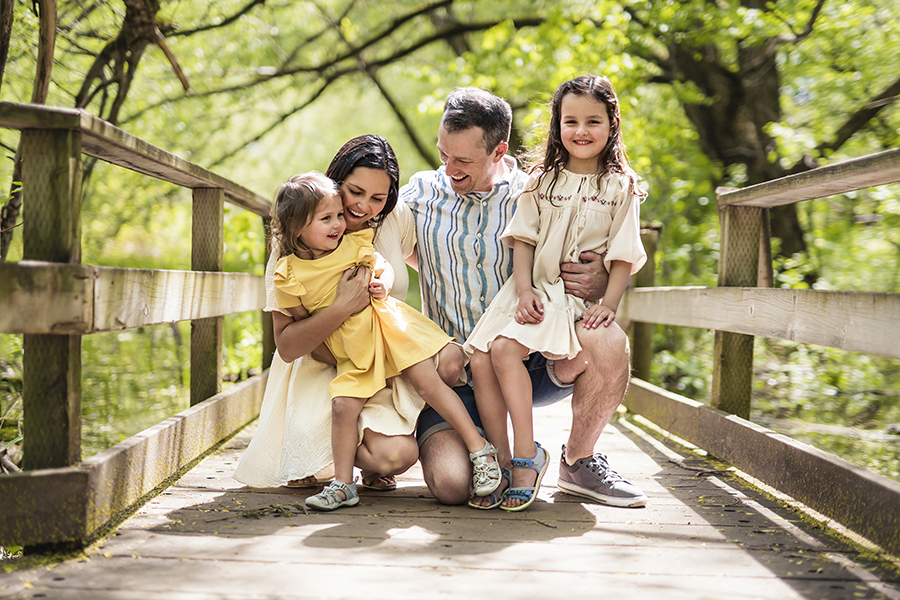 A Father and mother with the daughters having fun outside in forest